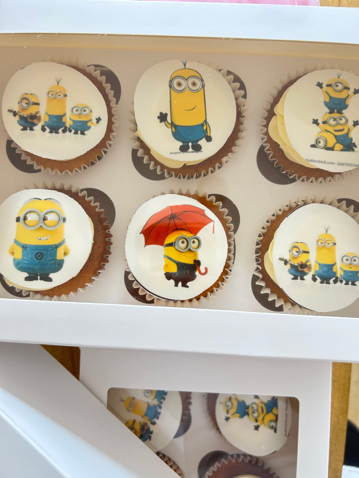 Cupcakes with Minion-themed decorations in a box with delivery in London and the Sevenoaks area.