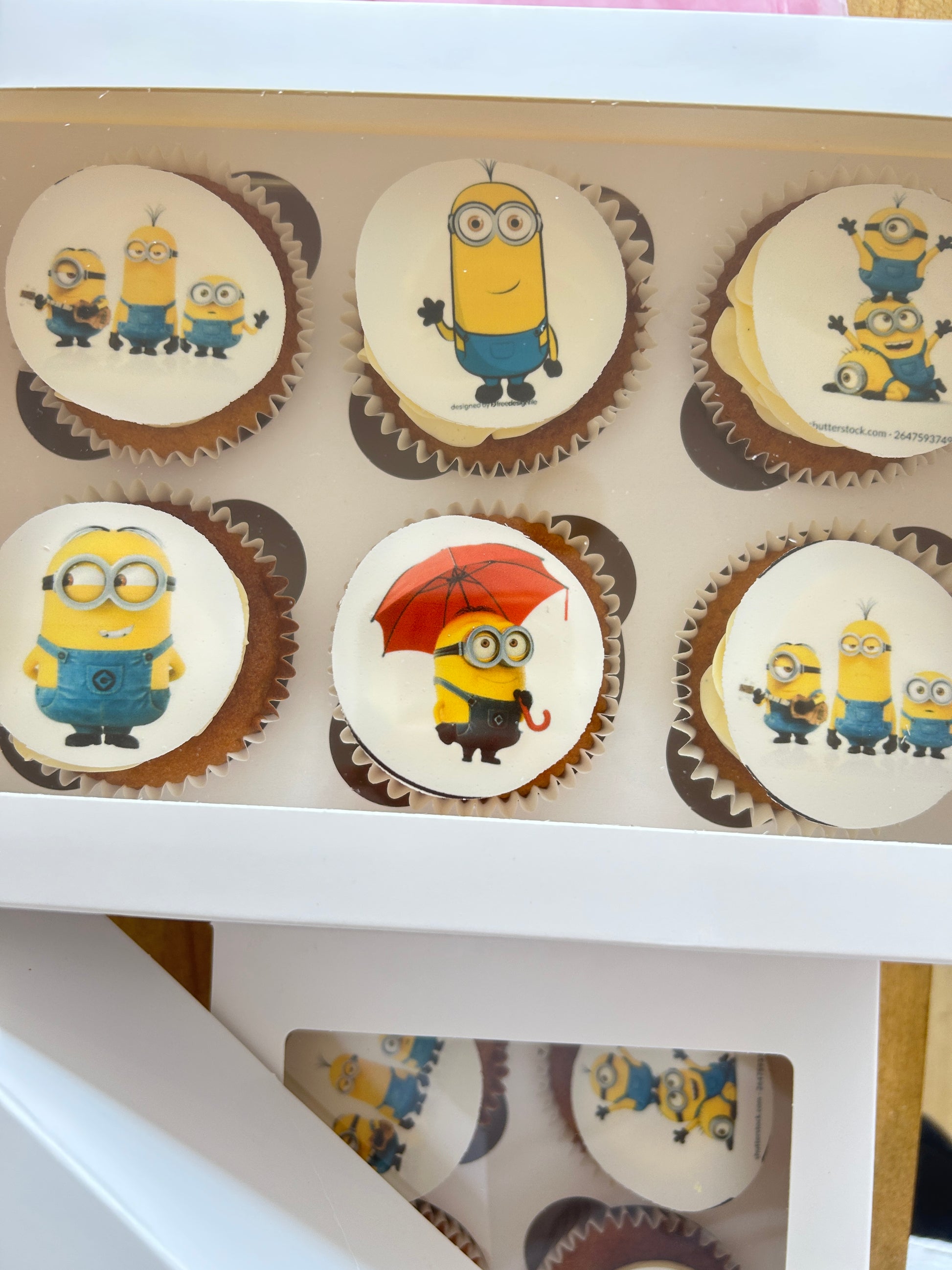 Cupcakes with Minion-themed decorations in a box with delivery in London and the Sevenoaks area.