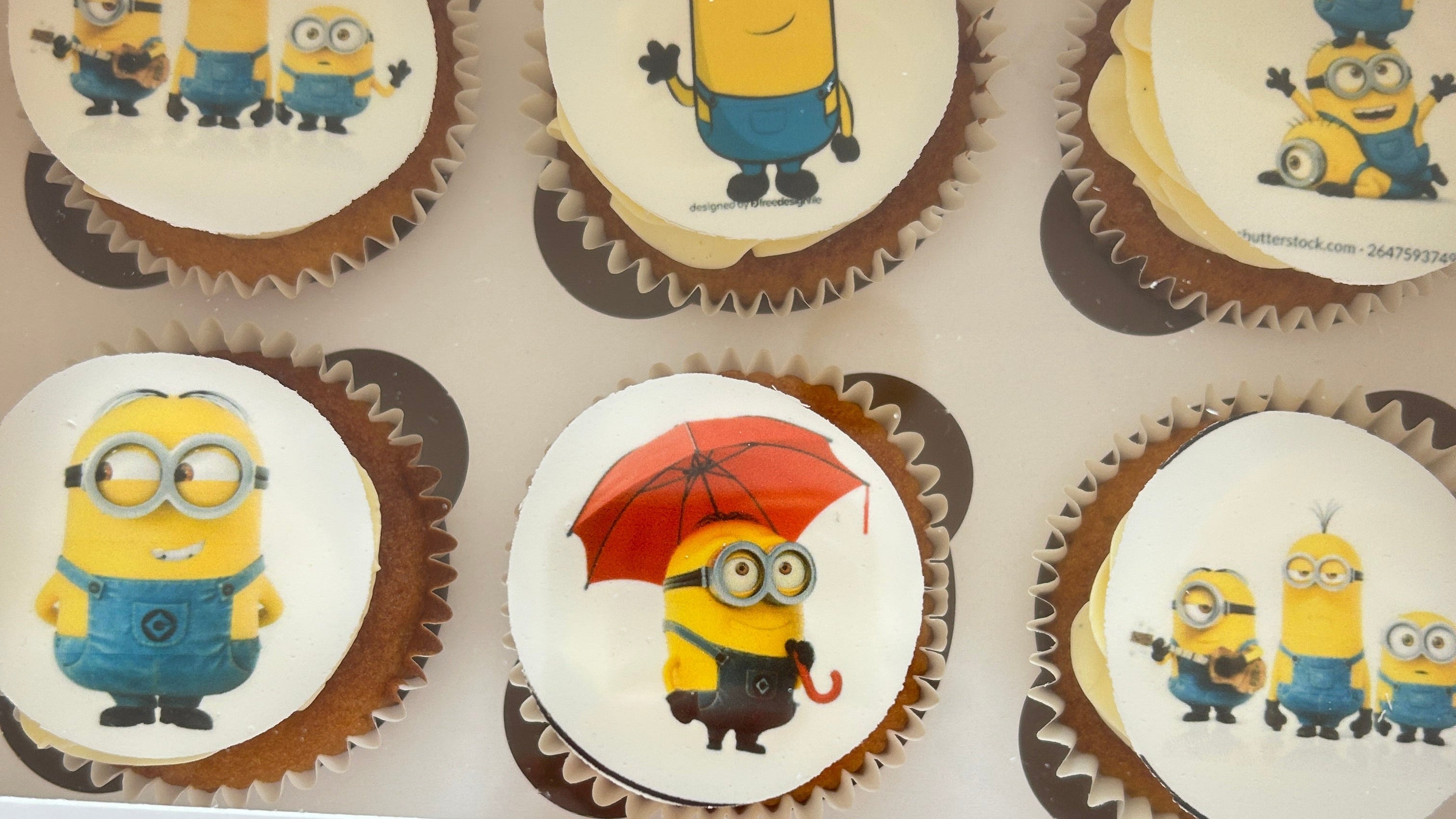 Cupcakes with Minion-themed decorations in a box with delivery in London and the Sevenoaks area.