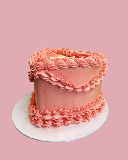 Pink frosted cake with vintage piping. Lambeth Cake