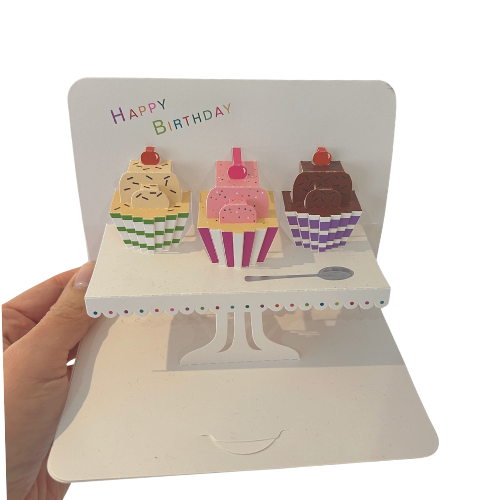 Pop-up birthday card with ice cream cake illustrations on a white background